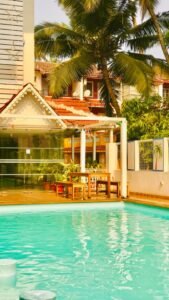 Modern residential flats in Porvorim, North Goa, surrounded by greenery and local roads.